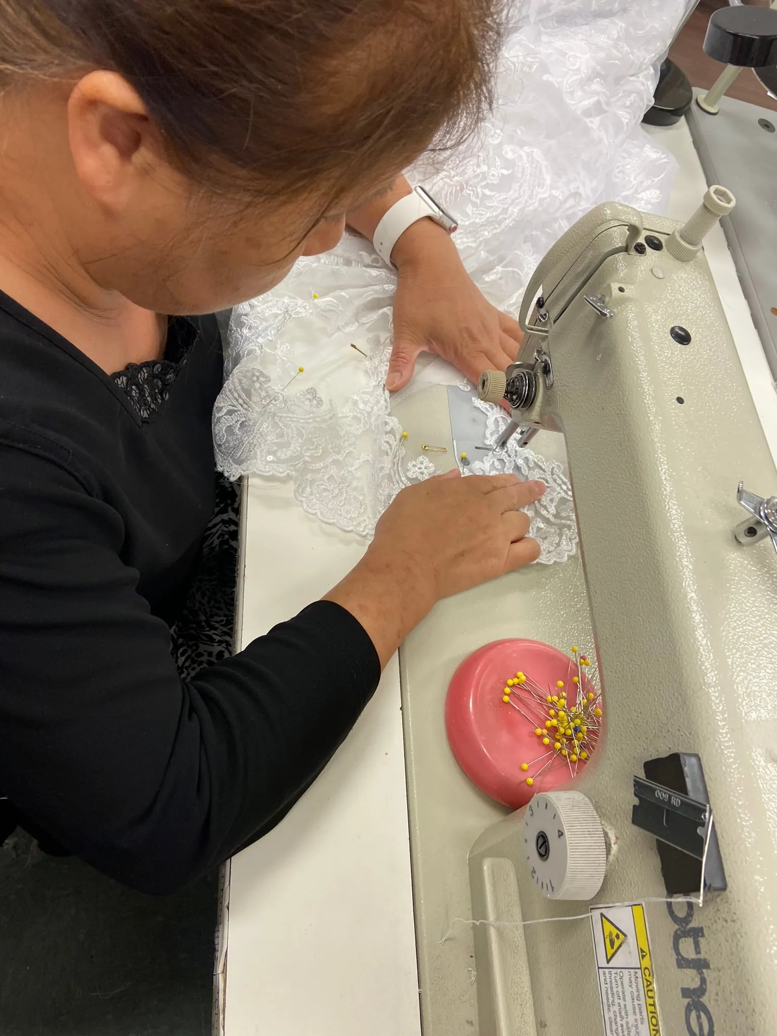 Angela working with a bridal gown